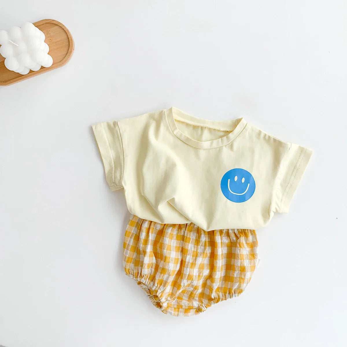 Baby unisex summer set featuring a smile face graphic tee and comfortable plaid shorts