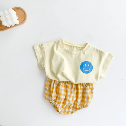 Baby unisex summer set featuring a smile face graphic tee and comfortable plaid shorts