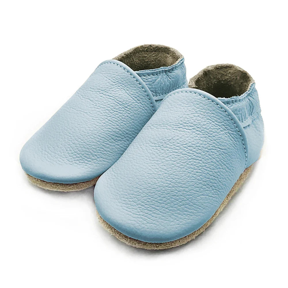 Close-up of the anti-slip soft sole on leather baby booties, infant first walking shoes
