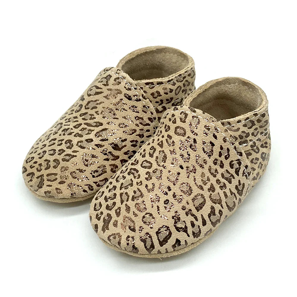 Stacked pile of soft leather baby booties, unisex options for newborn & infant shoes