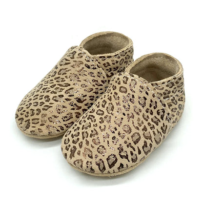 Stacked pile of soft leather baby booties, unisex options for newborn & infant shoes