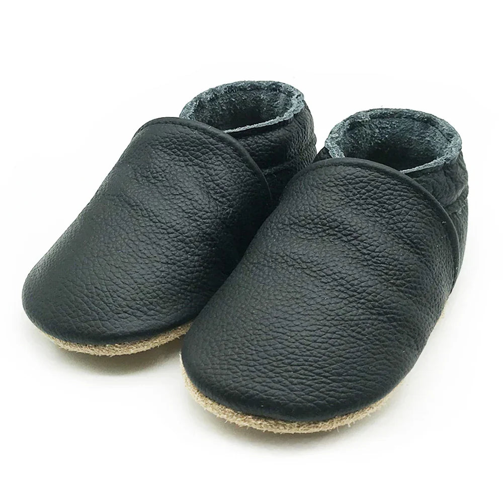 Close-up view of soft leather texture on baby booties, premium newborn & infant shoes