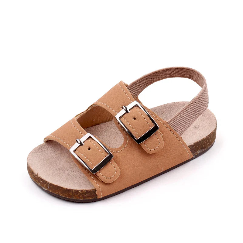 Summer infant footwear: soft sole baby sandals with practical dual buckles, promoting comfy steps.