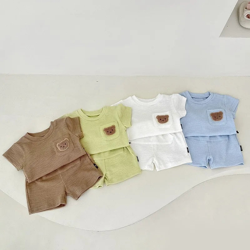 Summer baby outfit: bear embroidery detail on a comfortable top and simple everyday shorts.