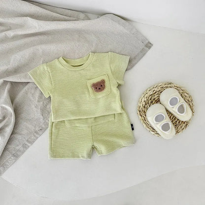 Baby girl's cute bear embroidered top and shorts outfit for sunny summer adventures.