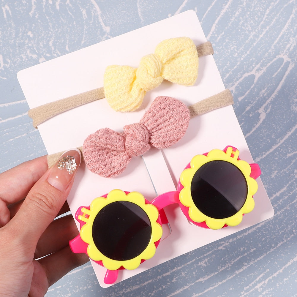 Stylish infant UV protective eyewear & bow. Essential baby accessory for sunny weather.
