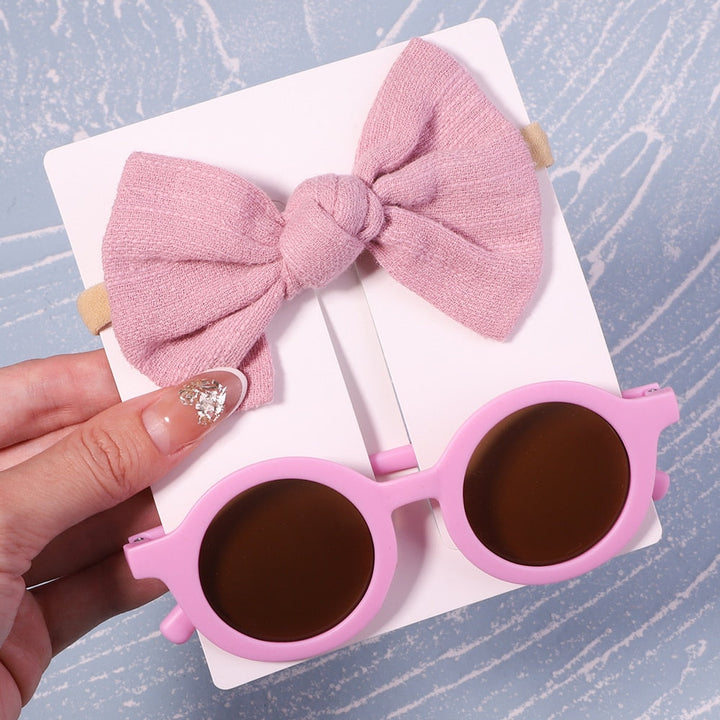 Durable baby UV sunglasses & cute bow. Perfect for active toddlers and outdoor play.