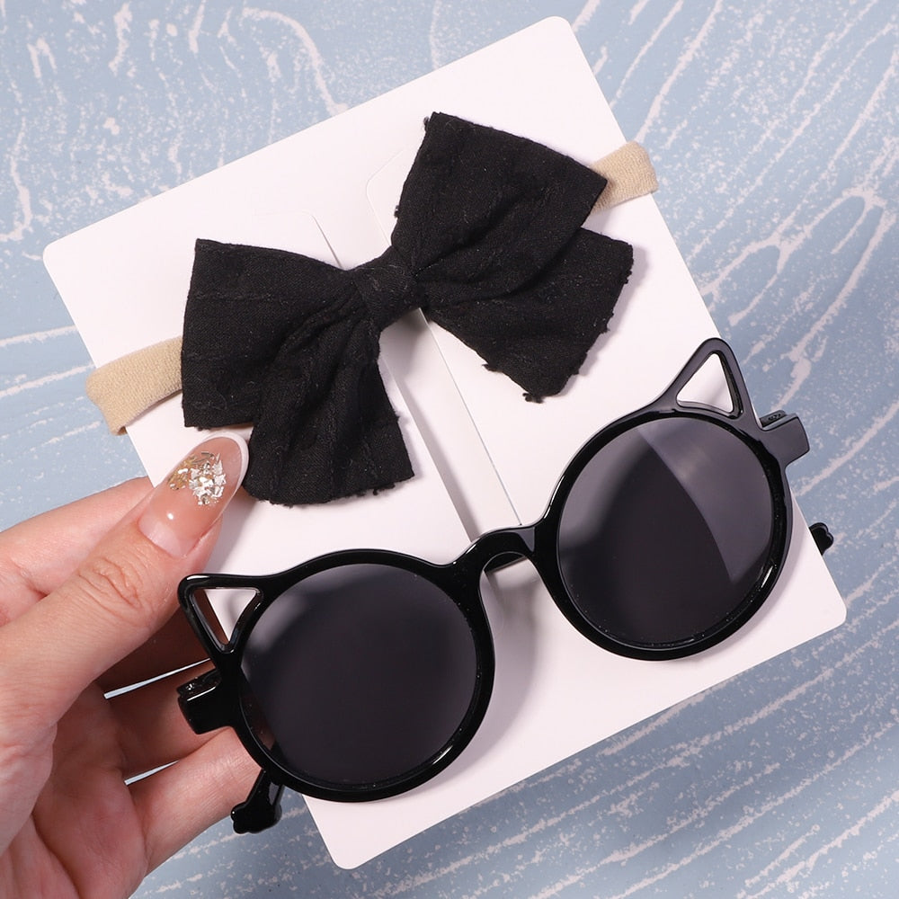 Premium baby UV sunglasses & stylish bow. Ensures optimal eye health & fashion statement.