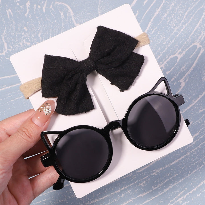 Premium baby UV sunglasses & stylish bow. Ensures optimal eye health & fashion statement.