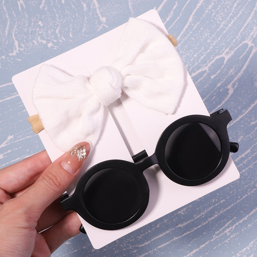 Cute baby sunglasses with matching bow. Trendy infant eye protection, perfect for baby fashion.