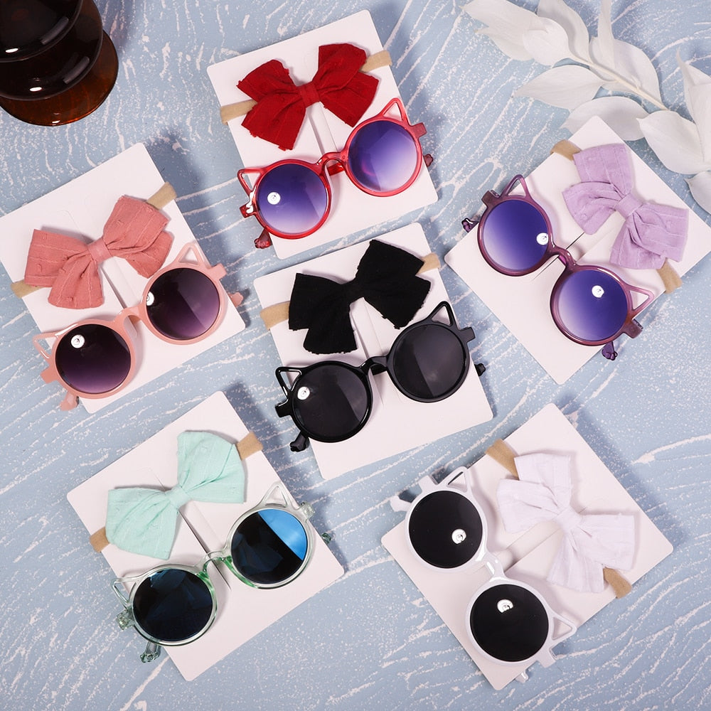 Flexible baby UV sunglasses & soft bow. Designed for infant comfort and durability.