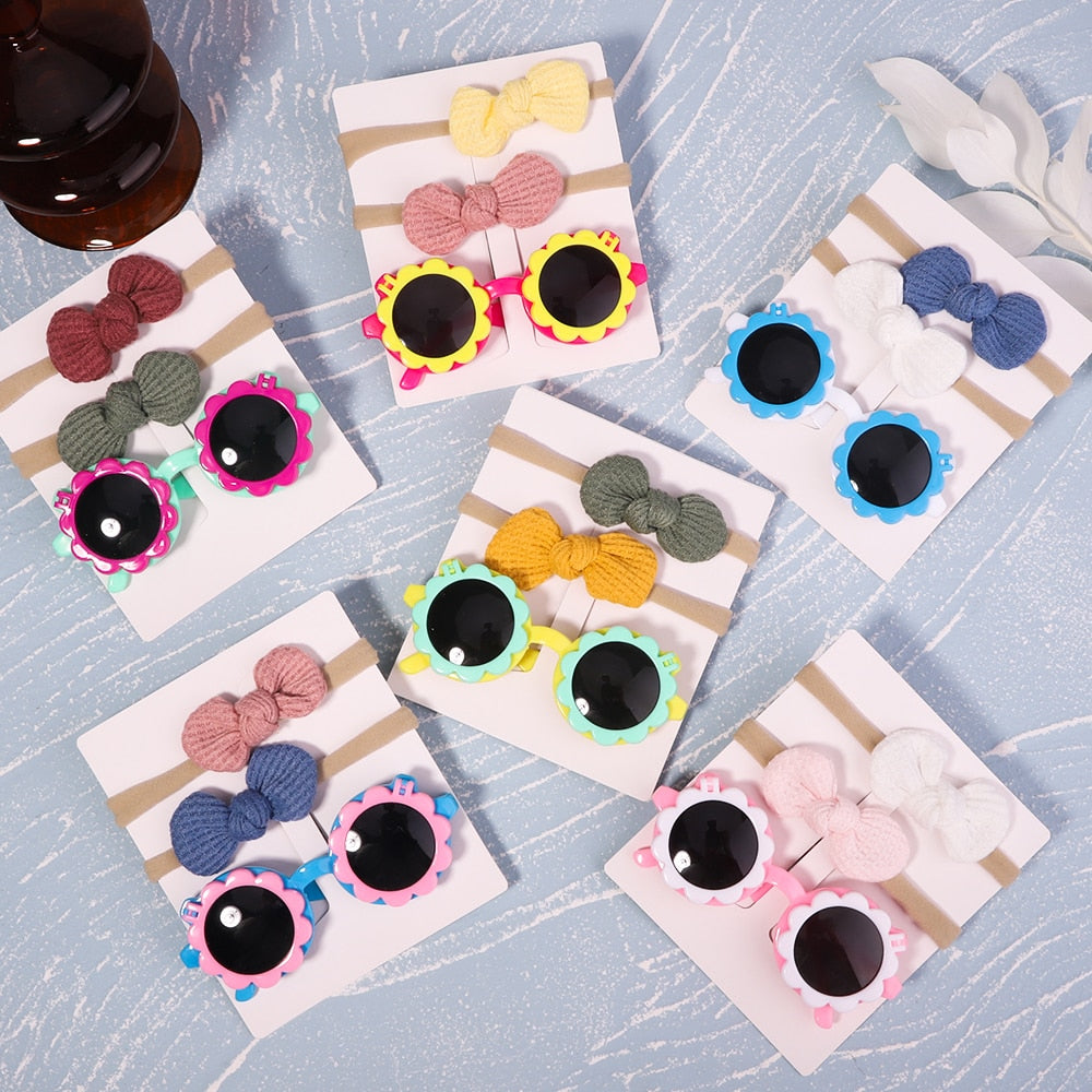 Everyday baby sun essential: UV protective sunglasses & bow set. Reliable eye safety & fashion.