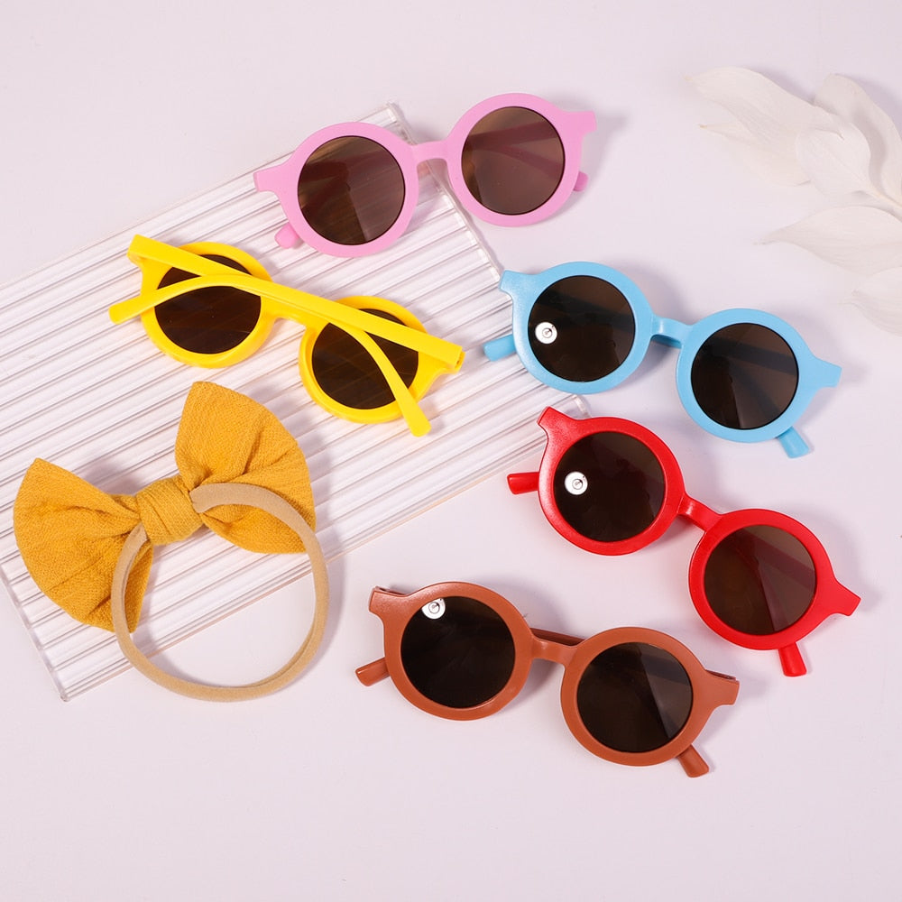 Practical infant UV sunglasses & cute bow set. Combines sun safety with adorable baby style.
