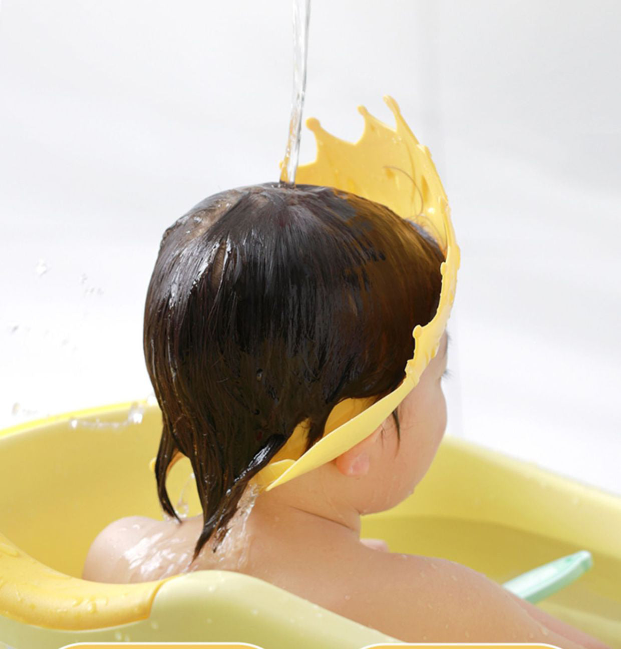 Close-up of a pink baby adjustable shampoo visor, showing waterproof material for no tears.
