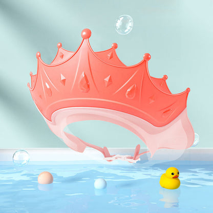 Toddler happily playing with bath toys while wearing an adjustable no-tears shampoo cap.