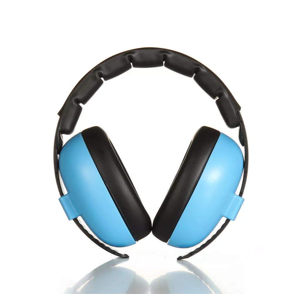 Newborn wearing tiny, soft noise cancelling earmuffs while traveling, promoting quiet sleep.