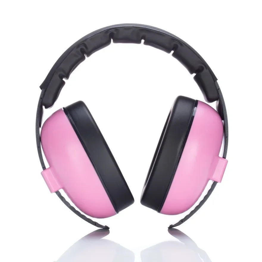 Toddler wearing noise cancelling earmuffs at a concert, comfortably protected from loud sounds.