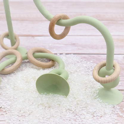 Collection of baby wood and silicone teethers in various colors, safe, non-toxic, for teething relief