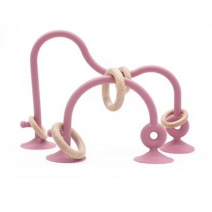 Angled shot of wood ring silicone teether, smooth finish, designed for infant mouth, baby essentials