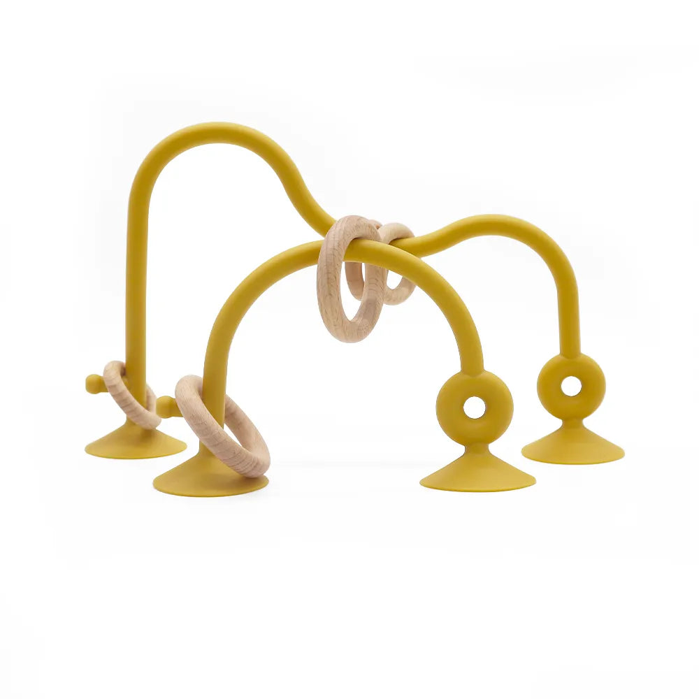 Baby playing with wood and silicone teether, provides tactile stimulation, great for teething babies