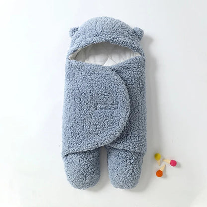 Baby wrapped in cozy fleece swaddle blanket for warm winter sleep.