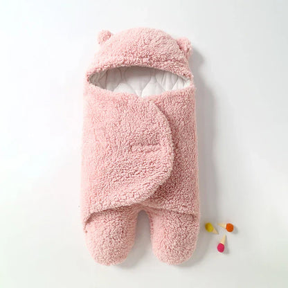 Sweet baby sleeping soundly in a cozy fleece infant swaddle.
