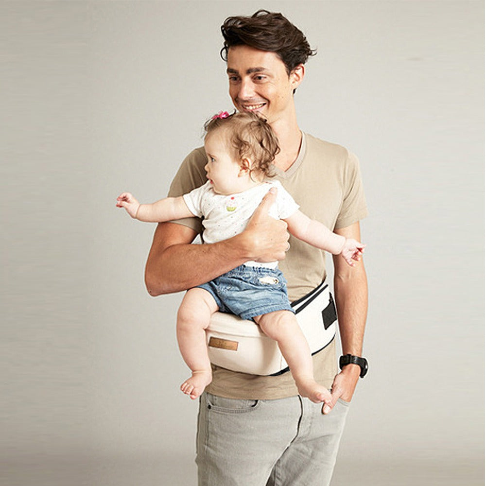 Side view of a black ergonomic baby hip seat carrier, highlighting the wide, supportive seat for baby