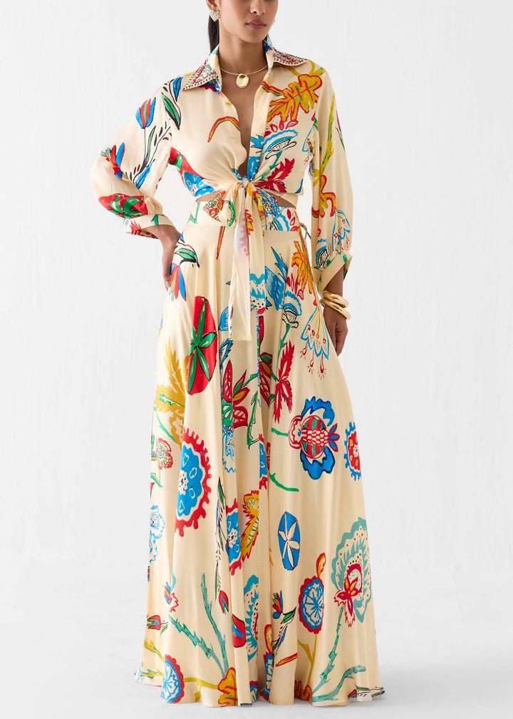 Beige floral two-piece set for women, featuring a tie-front shirt & flowy maxi skirt. Perfect for summer resort wear.