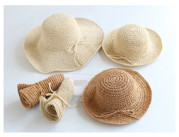 Beige foldable straw sun hat for children, ideal for beach & summer protection.