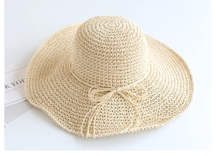 Durable beige straw hat for kids, foldable for convenient summer travel.