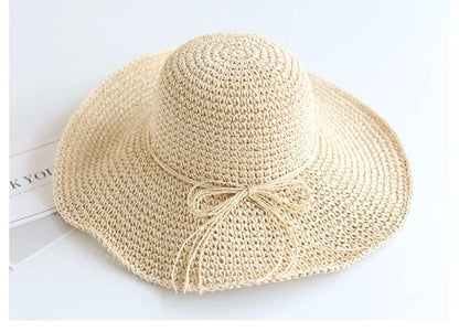 Durable beige straw hat for kids, foldable for convenient summer travel.