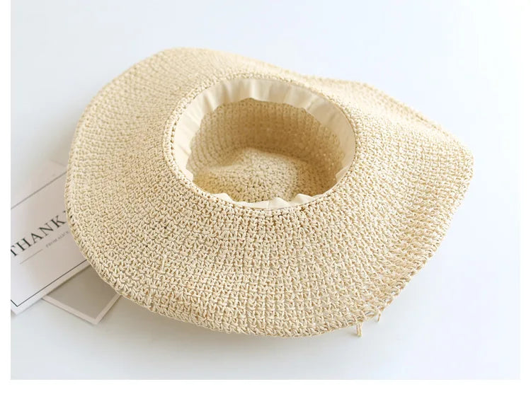 Kids' summer accessory: foldable beige straw hat, protects from sun.