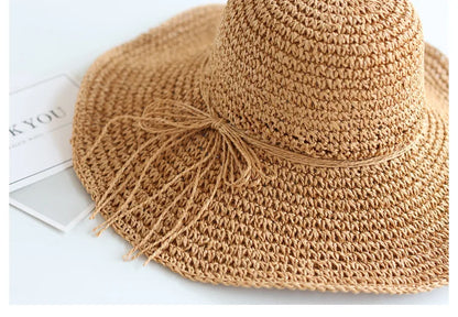 Beige straw sun hat for children, foldable and lightweight, great for holidays.