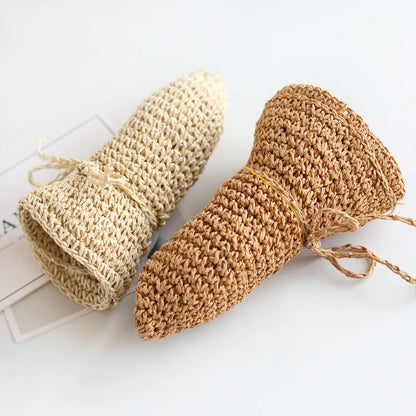 Foldable beige straw beach hat for kids, offering excellent sun protection.