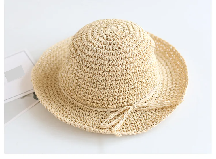 Baby accessory: children's brown straw sun hat, foldable for easy packing.