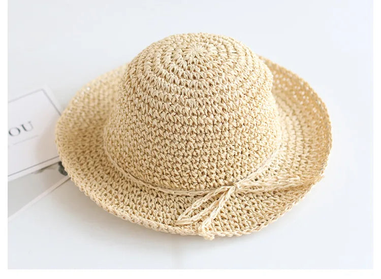 Foldable children's straw beach hat, brown, keeps kids cool & protected.