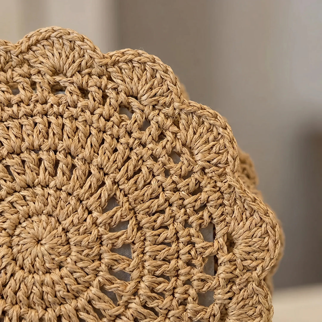 Close-up of women's textured crossbody bag, highlighting the elegant scalloped flap and soft, durable fabric.