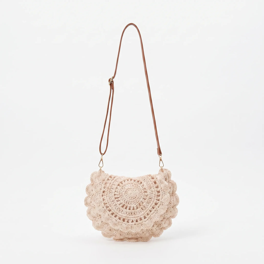 Stylish women's beige crossbody bag with a distinctive scalloped flap and textured finish, ideal for daily use.