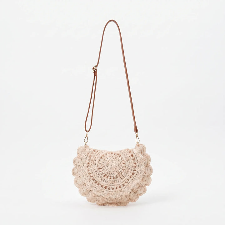 Stylish women's beige crossbody bag with a distinctive scalloped flap and textured finish, ideal for daily use.