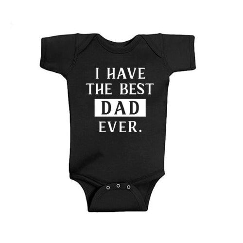 Father and child wearing 'Best Dad' matching white cotton blend t-shirts for family photoshoot