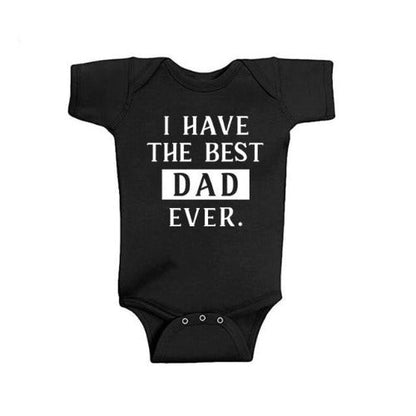 Father and child wearing 'Best Dad' matching white cotton blend t-shirts for family photoshoot