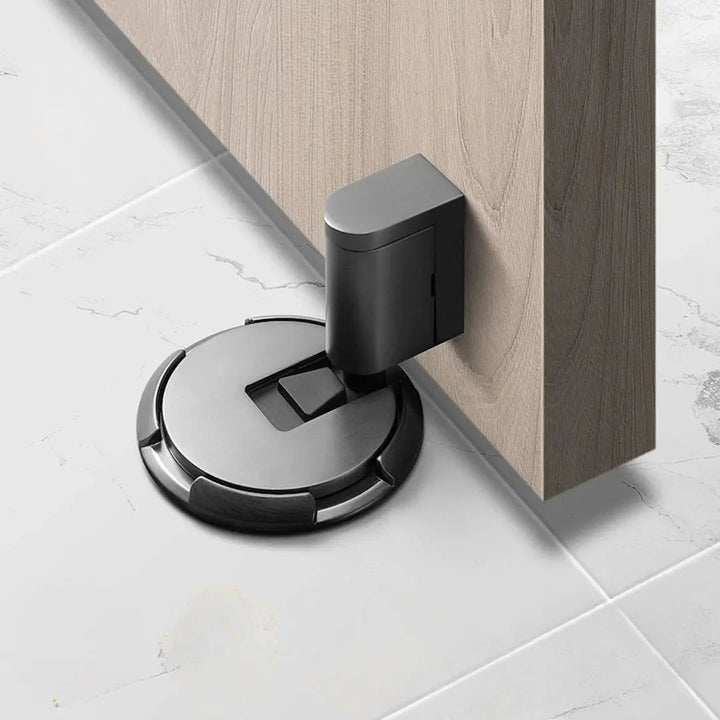 Magnetic door holder, black. Self-adhesive, no drilling for quick installation. Prevents door slams & wall damage.