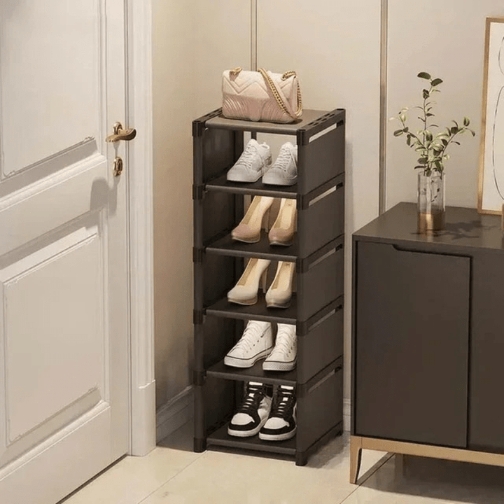 Compact black shoe organizer within a closet corner, ideal for space-saving shoe storage.