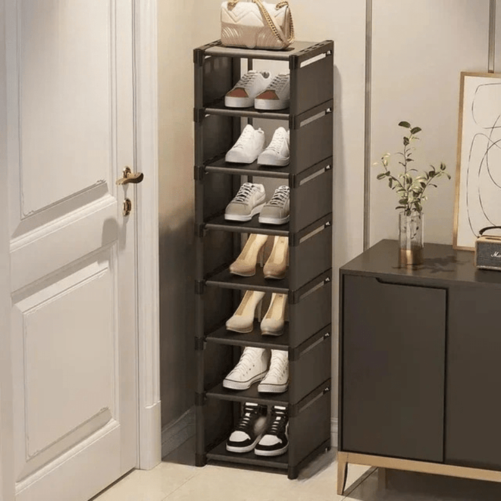 Multi-layer black shoe rack displaying various shoes, efficient corner storage for home organization.