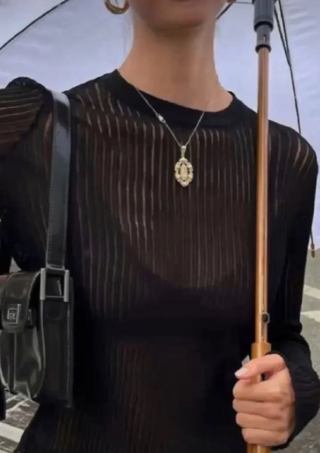 Elegant black sheer textured long sleeve top, a versatile women's fashion piece for trendy outfits.