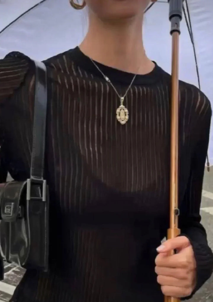 Elegant black sheer textured long sleeve top, a versatile women's fashion piece for trendy outfits.