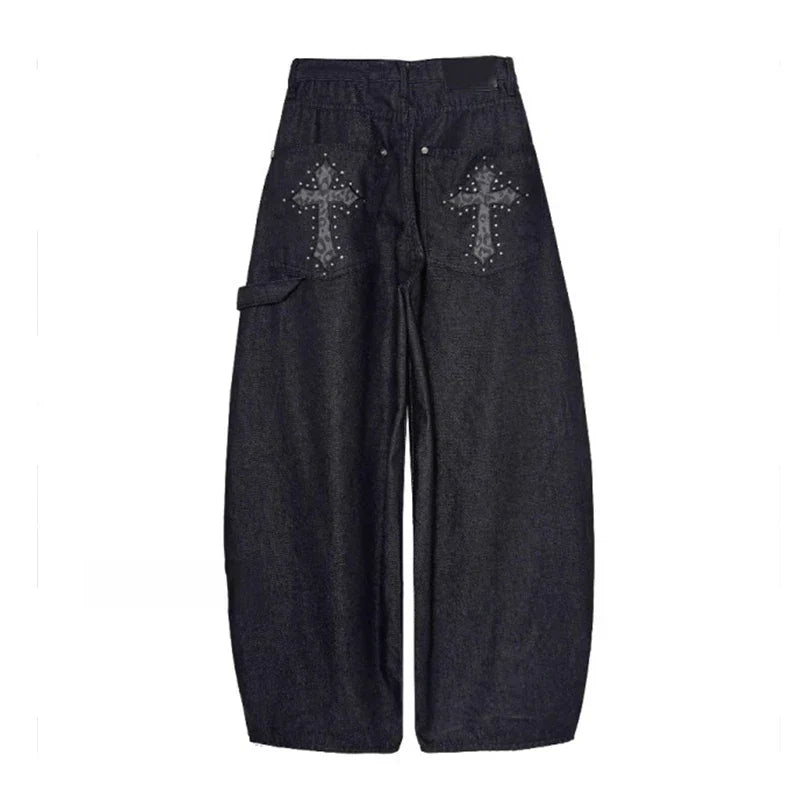Detail of black studded wide-leg pants. Features unique stud embellishments, baggy silhouette, and low-rise design.
