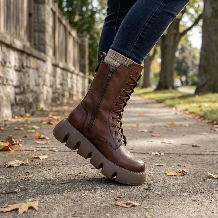 Black women's combat boots with arch support, chunky platform sole & lace-up design for comfortable everyday wear.