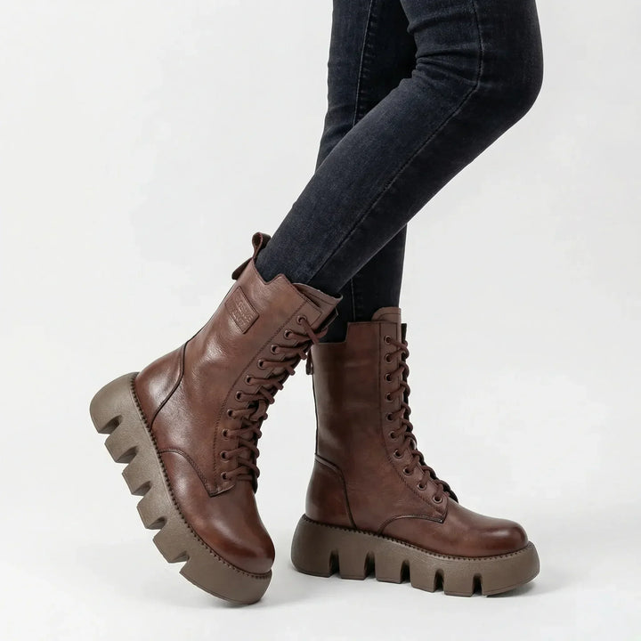 Stylish women's platform combat boots, lace-up front, engineered with arch support for foot comfort & stability.