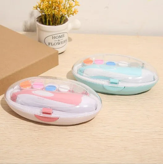 A maternity gift set featuring a blue baby electric nail trimmer and other grooming tools.